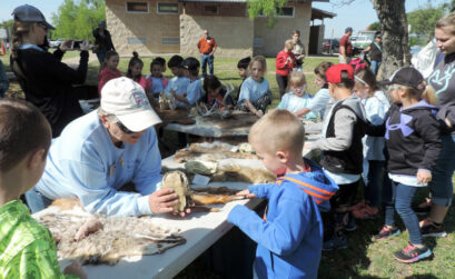 Judy Harrison, a member of the Highland Lakes Master Naturalists, shows a turtle shell to a young visitor during the Greater Outdoor Program at Inks Lake State Park. The organization teams up with the state park to present the program to more than 500 elementary school students and 200 teachers and parents from across the Highland Lakes. Members put in thousands of volunteer hours a year to educate people on the importance of nature. Courtesy photo by Sue Kersey/Highland Lakes Master Naturalists