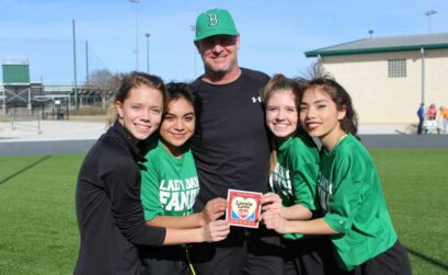 Burnet High School cross-country head coach Rich Wilson (center) with student-athletes junior Brie Luedecke (left), freshman Rose Flores, freshman Chantel Manguia, and senior Julyssa Silva. Wilson was voted the 2018 Locals Love Us favorite school coach in the Burnet area by The Picayune readers and KBEY 103.9 FM Radio Picayune listeners. Staff photo by Jennifer Fierro