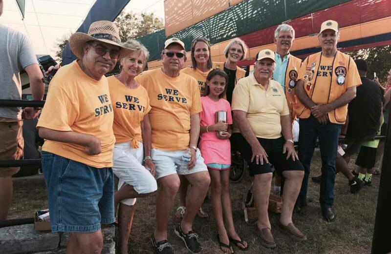 Bobby Kinard, Gennie Ward, Jim Chapman, Teresa Gray, Betty Hall, Jim Hartwell, Ron Hall, and Jay Ward with a camper volunteering at an annual Lions Camp in Kerrville during a cleanup event in 2017. Courtesy photo