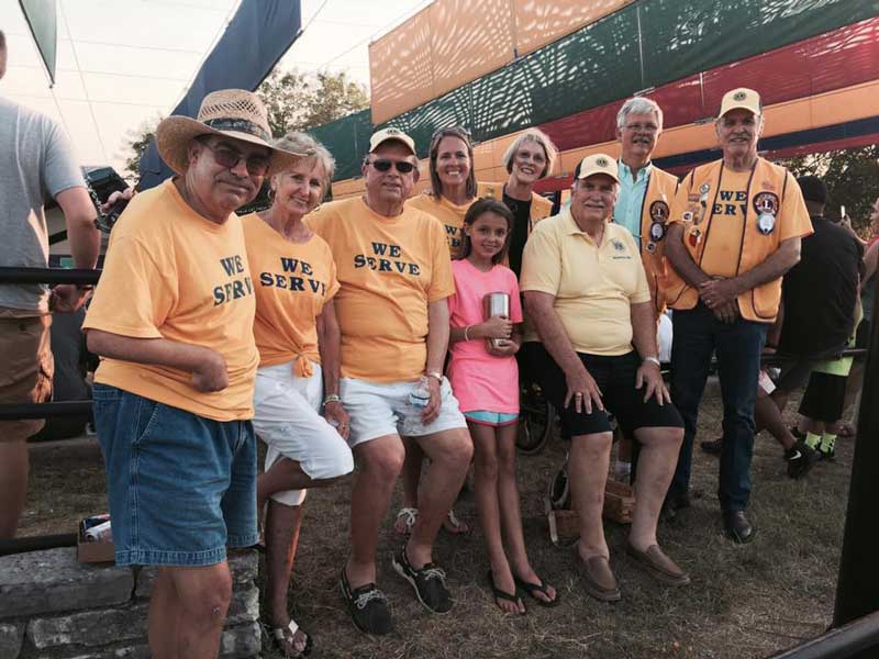 Bobby Kinard, Gennie Ward, Jim Chapman, Teresa Gray, Betty Hall, Jim Hartwell, Ron Hall, and Jay Ward with a camper volunteering at an annual Lions Camp in Kerrville during a cleanup event in 2017. Courtesy photo