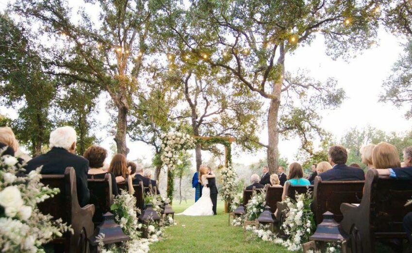 Couples love outdoor weddings in the Highland Lakes for the beautiful sunsets, old oak trees, expansive views, and waterfront lawns. Cedar Skies at Log Country Cove (pictured) is a favorite wedding venue for all of those reasons. Photo courtesy of Helo Photography