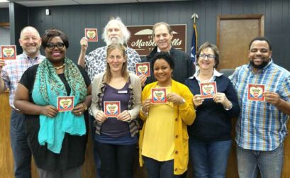 Members of the Marble Parks and Recreation Department happily accepted the Locals Love Us award for favorite park for Johnson Park. They include parks and public works administrative assistant Monique Breaux (front row, left), parks and recreation chairwoman Kendra Lewis, Commissioners Anitra Torns, Ann Berg, and Dedrick Thompson, Director Robert Moss (back row, left) and Commissioners Charles Watkins and Steve Hurst. Staff photo by Jennifer Fierro