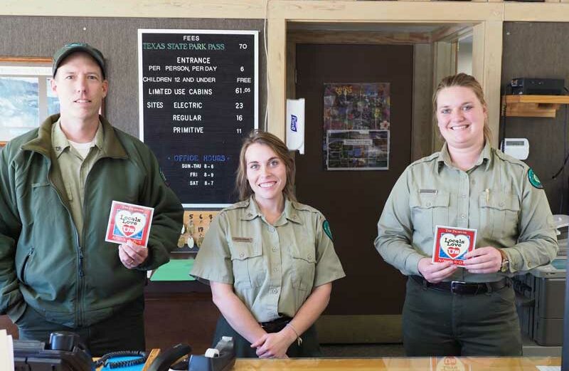 Inks Lake State Park superintendent Cory Evans (left) and park staff Crystal Kohanek and Kristen New show off their 2018 Locals Love Us wins. The Picayune readers and KBEY 103.9 FM Radio Picayune listeners voted Inks Lake the 2018 Locals Love Us favorite park and the place for their favorite outdoor activity (hiking) as well as for favorite marina/water activities and campsites. Staff photo by Daniel Clifton