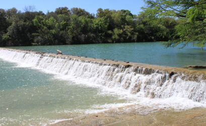 This waterfall, created by a dam at Blanco State Park, is a favorite for people looking to cool off in the water. Staff photo