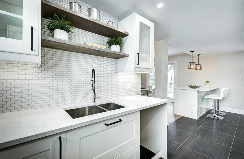Cleaning up the clutter in the kitchen might be the hardest part of staging a home for sale. No family photos or school schedules on the refrigerator and no appliances, drying dishes, or family detritus on cabinet and table surfaces. Potential buyers should see the house and little else.