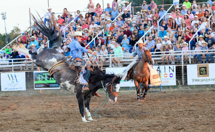 A bronc rider from the 2022 Marble Falls Rodeo hangs on tight. The 2023 rodeo is July 21-22 at the Charley Taylor Arena. Photo by Craig Lusinger