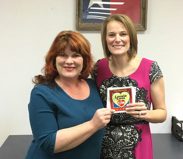 Cindi Ashford-Fry of The Picayune/KBEY presents Burnet County District Clerk Casie Walker (right) with the 2016 Locals Love Us award for favorite government employee for the Burnet area. Courtesy photo