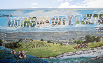 The Johnson City mural showcases Hill Country grandeur at its finest. While the rustic charm surrounding the city draws you in, the bounty of bars, boutiques, and restaurants will keep you there. Staff photo by Dakota Morrissiey