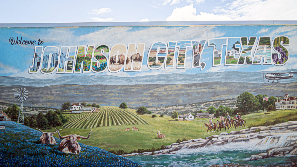 The Johnson City mural showcases Hill Country grandeur at its finest. While the rustic charm surrounding the city draws you in, the bounty of bars, boutiques, and restaurants will keep you there. Staff photo by Dakota Morrissiey