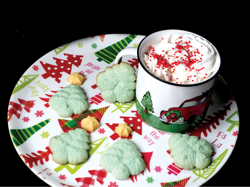 Daniel Clifton and his sons, Luke and Zach, baked these spritz cookies from a recipe book Daniel's late mother used. The project helped the author connect with his story and provide some artwork. Staff photo by Daniel Clifton