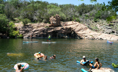 Families and friends enjoy Devil’s Waterhole at Inks Lake State Park on a sunny day in July. Tubing, paddleboarding, leaping, and lounging are all favorite activities at this Highland Lakes hideaway. Staff photo by Dakota Morrissiey
