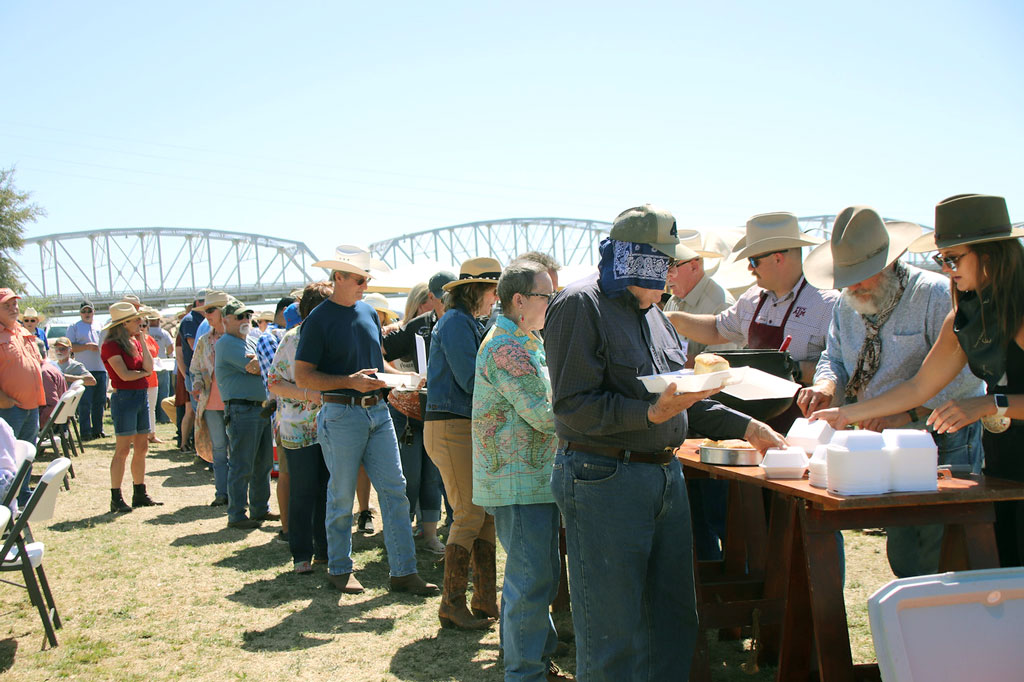 Hungry people line up for the public meal at the 2022 Llano River Chuck Wagon Cook-off. Tickets for the 2023 meal went on sale Feb. 15. Photo by Martelle Luedecke/Luedecke Photography