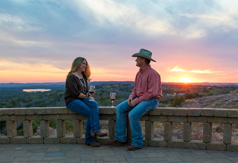 Whitney and James Hebert of Burnet enjoy the sunset at Torr Na Lochs Vineyard & Winery west of Burnet. You can sample a Highland Lakes wine at one of several wineries. File photo