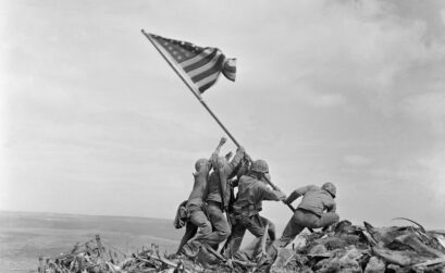Five US Marines and a Navy corpsman raise the flag atop Mount Suribachi on February 23, 1945, during the Battle of Iwo Jima. Photo by Joe Rosenthal
