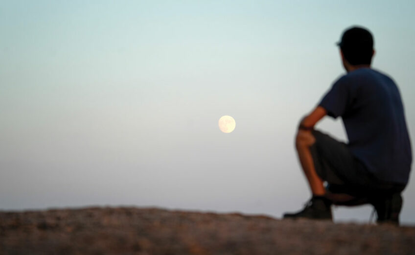 Photographer and friend Kevin Ting watches the full moon rise over Enchanted Rock. Ting planned the photo out and I took the picture. Staff photos by Dakota Morrissiey