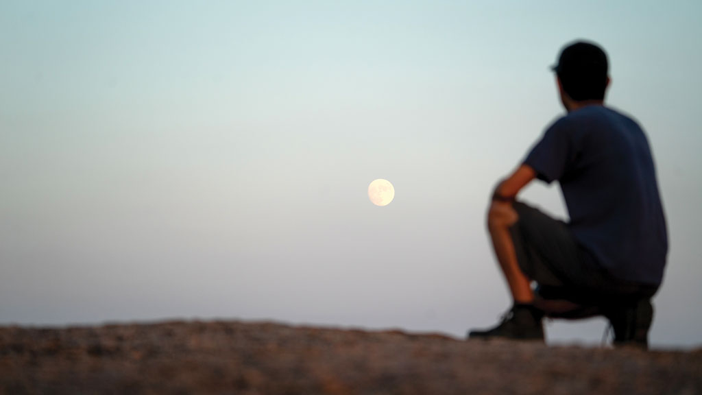 Photographer and friend Kevin Ting watches the full moon rise over Enchanted Rock. Ting planned the photo out and I took the picture. Staff photos by Dakota Morrissiey