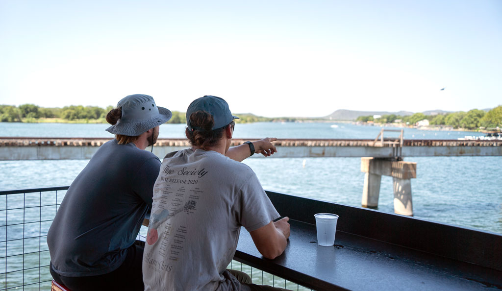 Tate Gregory and Matthew Smith, two vignerons from William Chris Vineyards in Hye, take their lunch break at Wakepoint LBJ in Kingsland. Wakepoint is a hotspot for boaters and Kingsland locals that overlooks the merging of the Colorado River, the Llano River, and Lake LBJ. Staff photo by Dakota Morrissiey