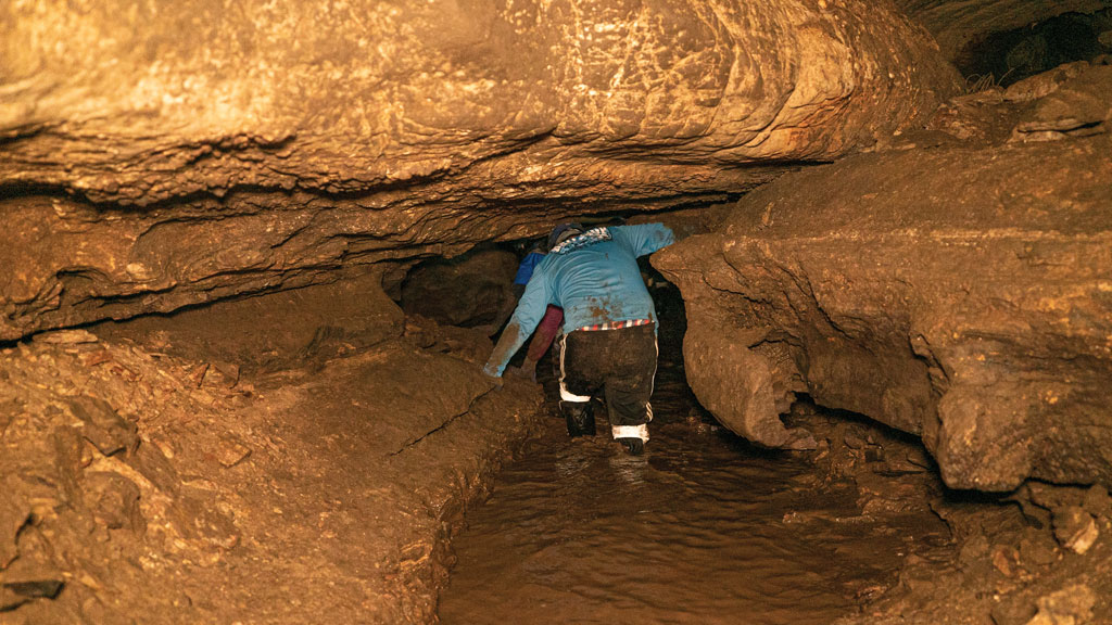 Paul Domingo, a native of Tyler, sloshed ahead of me through the partially flooded portions of the caverns. Depending on the weather, the whole cave system can be flooded out. Staff photo by Dakota Morrissiey