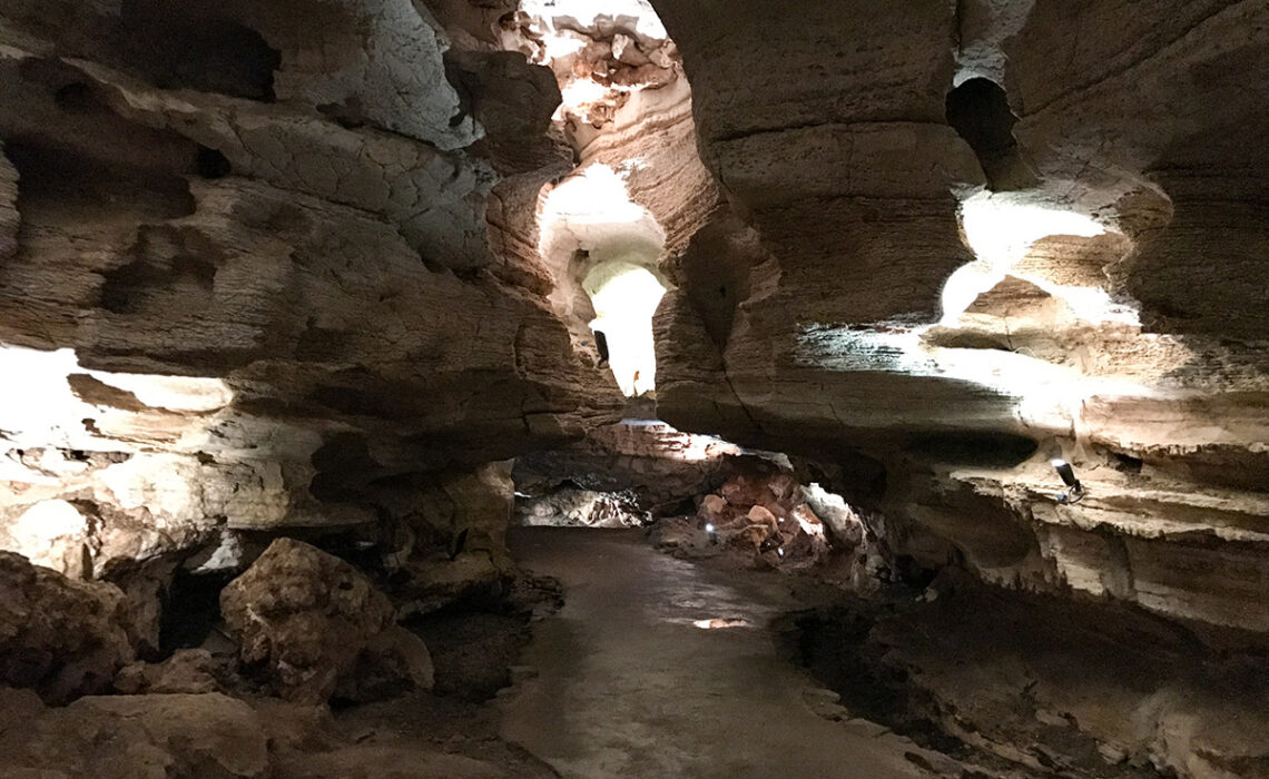 Longhorn Cavern State Park is a unique flow cave in the Hill Country. Its distinctly smooth walls and level path are characteristic of the way it was formed by rushing water. Photo by JoAnna Kopp