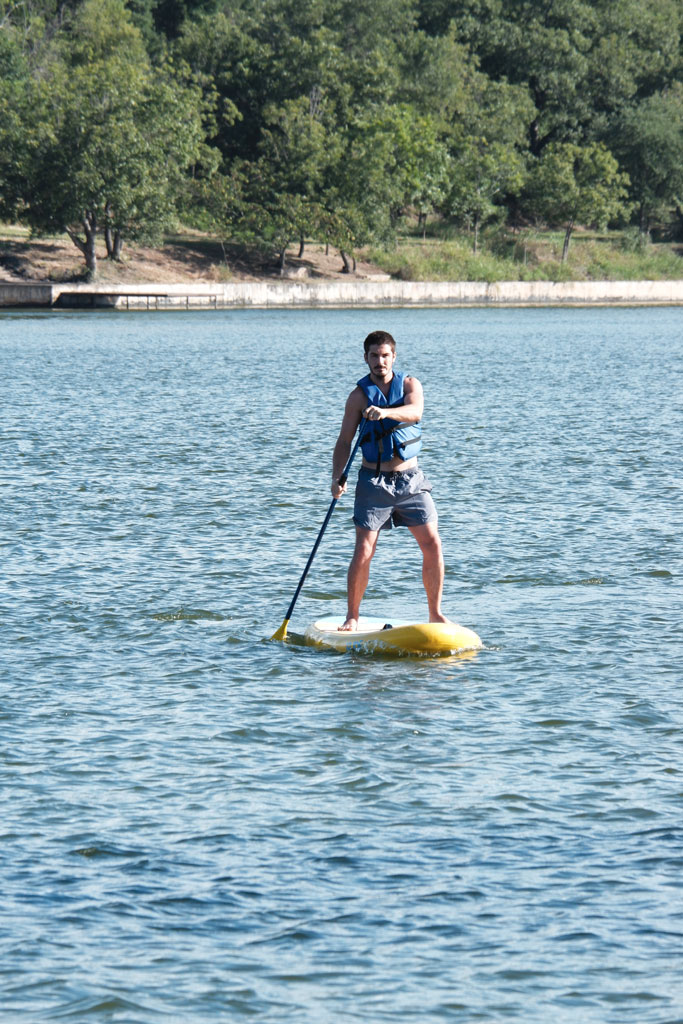Writer Dakota Morrissiey got the hang of standup paddleboarding on his first outing on Lake Marble Falls. Staff photo by David Bean
