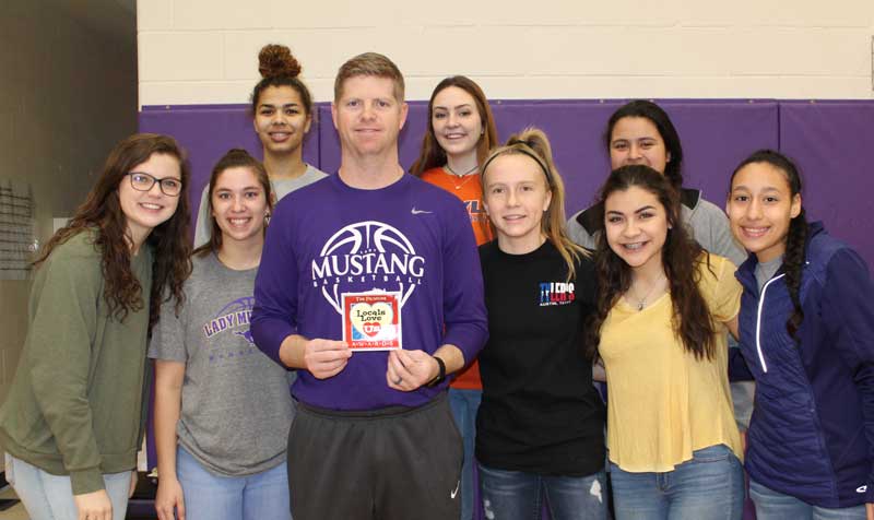 Marble Falls High School girls head basketball coach John Berkman (center) is the 2018 Locals Love Us favorite coach in the Marble Falls area as voted on by The Picayune readers and KBEY 103.9 FM Radio Picayune listeners. He is surrounded by the Lady Mustangs. Staff photo by Jennifer Fierro