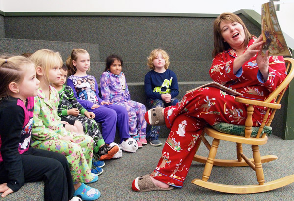 Spicewood Elementary School Principal Leslie Baty reads a Christmas story to several students on the campus' last day if class before Christmas break. Staff photo by Daniel Clifton