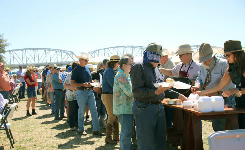 Hungry people line up for the public meal at the 2022 Llano River Chuck Wagon Cook-off. Tickets for the 2023 meal went on sale Feb. 15. Photo by Martelle Luedecke/Luedecke Photography