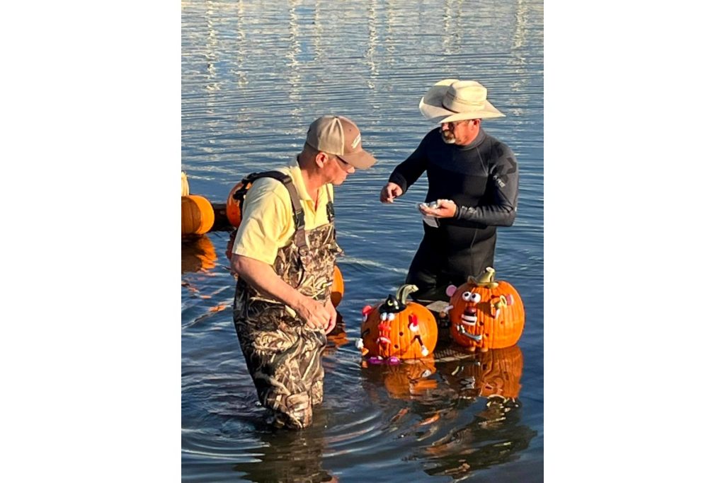 Men with pumpkins floating in the river.