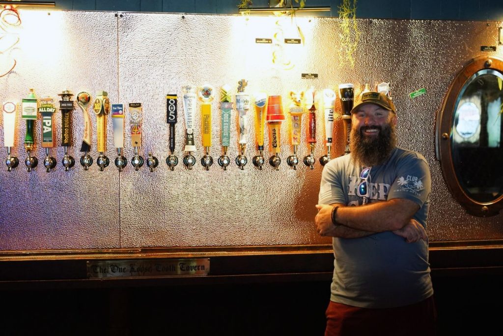 Bartender in front of beer taps